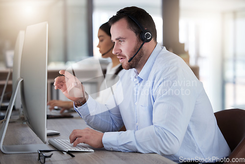 Image of Call center, consulting and computer with man in office for communication, customer service or help desk. Telemarketing, sales and advice with male employee for commitment, contact us and hotline