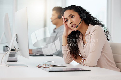 Image of Business woman, call center and frustrated in customer service, stress or burnout at office. Annoyed and tired female person, consultant or agent talking to difficult client or complaint at workplace