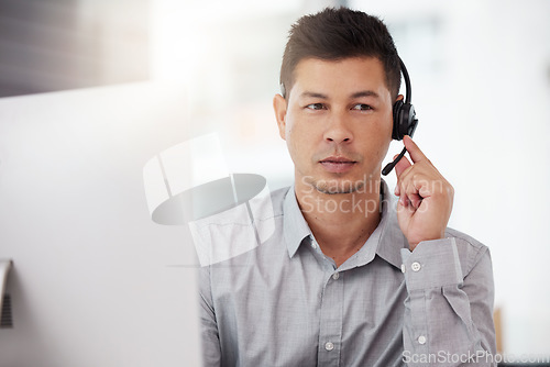 Image of Businessman, call center and headphones in customer service, support or telemarketing at the office. Man consultant or agent with headset for online advice or telesales in contact us at the workplace