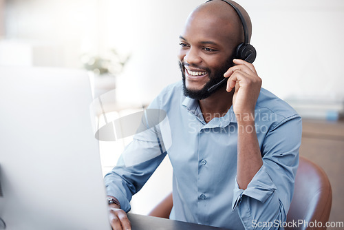 Image of Black man, happy and agent working in call center on computer in the office, business in telemarketing or customer service. Businessman, face with smile and crm, conversation with client on help desk