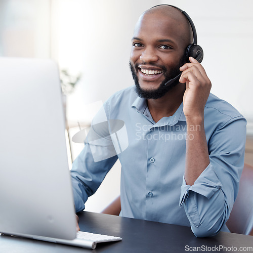 Image of Black man, callcenter with phone call and computer, communication with headset and contact us in office. Male consultant in portrait, customer service and tech support with help desk worker and smile