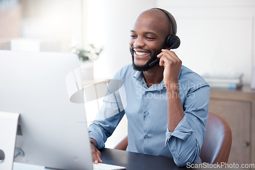 Image of Black man, callcenter with phone call and contact us, communication with headset and CRM in office. Male consultant at computer, customer service or telemarketing, tech support and help desk worker