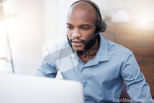 Image of Black man, call center employee and CRM with contact us, communication and computer, headset with mic and connect. Male consultant, customer service and tech support with help desk worker in office