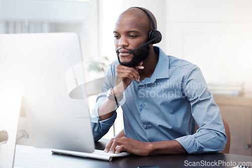 Image of Black man, computer and call center, thinking with contact us and communication, concentrate with headset and connect. Male agent with focus, customer service and help desk employee is reading online