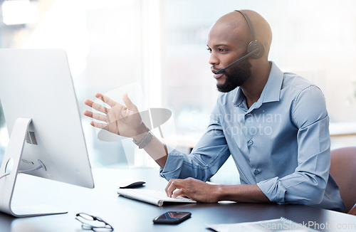 Image of Black man at computer, callcenter and contact us, phone call communication with headset and talking. Male agent in office, customer service and help desk employee with tech support and discussion