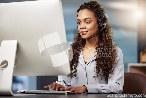 Image of Call center, virtual assistant or woman typing on computer at telecom customer services office job help desk. Microphone, technology or female sales agent consulting or helping in tech support on pc