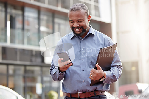 Image of Businessman, phone and typing an email at office, building and corporate workplace communication. Happy, senior and black man on mobile, smartphone or technology for online search, text or contact