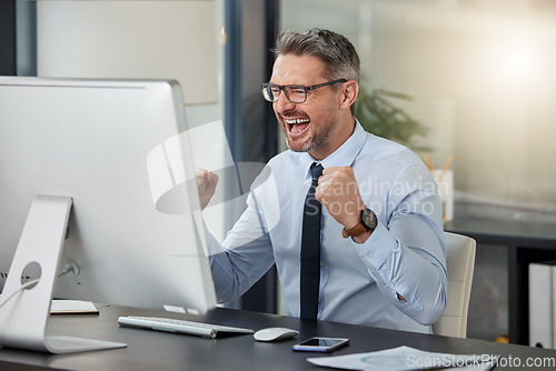 Image of Happy, businessman and fist in celebration for winning, success or promotion by desk at office. Man employee in joy for win, achievement or bonus on computer in sale, discount or prize at workplace