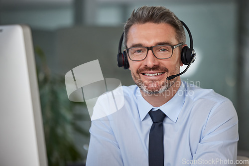 Image of Businessman, call center and portrait smile in telemarketing, customer service or support at office. Happy man, consultant or agent smiling with headphones for online advice or telesales at workplace