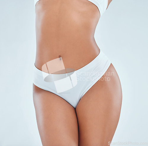 Image of Body, stomach and a woman with underwear for femininity isolated on a white background in studio. Skin, healthy and a toned person and legs of a girl in lingerie for wellness and feminine empowerment