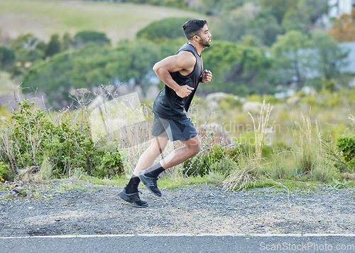 Image of Man is running outdoor, fitness and cardio in nature with exercise and healthy, active body. Male runner on side of road, train for marathon with speed, energy and workout for health and sport