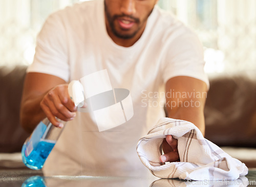 Image of Man, clean table with chemical and cloth, detergent spray and wipe dirt from furniture. Housekeeping, male person cleaning home with bottle and disinfecting surface from bacteria with hygiene