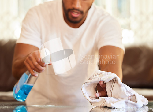 Image of Man, clean table with spray and cloth, chemical detergent and wipe dirt from furniture. Housekeeping, male cleaner hands with closeup and hygiene, cleaning house with bottle and disinfecting surface