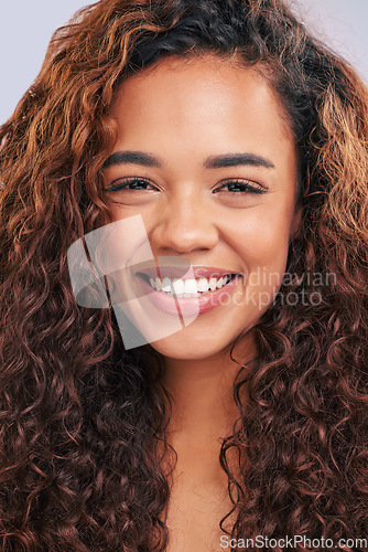 Image of Woman, natural hair and curly hairstyle in studio with smile and glow. Face portrait of African person with beauty and healthy curls as benefits or results of shampoo or cosmetics on white background