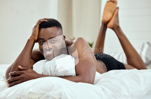 Image of Happy, smile and portrait of black man in bedroom for relax, confident and comfortable. Happiness, calm and weekend with male person in bed at home for free time, morning routine and wake up