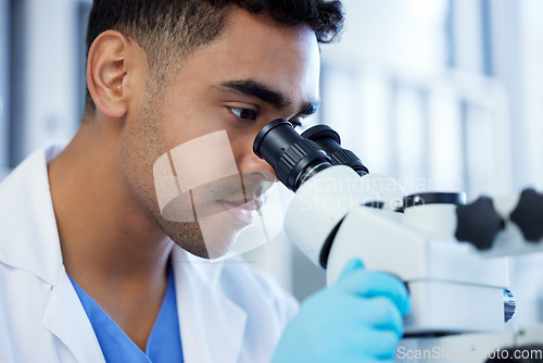 Image of Science, innovation and a man with microscope in a lab for medical research and analysis. Serious, medicine and a scientist doing a check of chemistry, microbiology or a virus working at a clinic