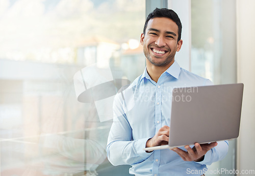 Image of Businessman, smile portrait and laptop at office window with internet connection and career pride. Happy asian male entrepreneur with technology, internet and space for networking, email and work