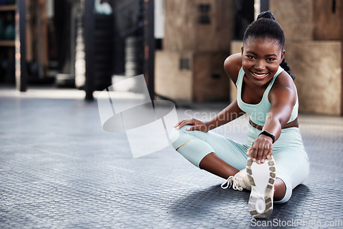 Image of Fitness, black woman and stretching legs in gym for health or preparing for workout or flexibility and mobility. Train, wellness and African female athlete or warmup or cardio exercise and routine