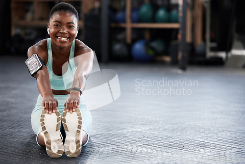 Image of Music, portrait or happy girl in gym stretching legs for fitness workout or body movement with audio. Streaming radio, headphones or black woman smiling in exercise training warm up for flexibility