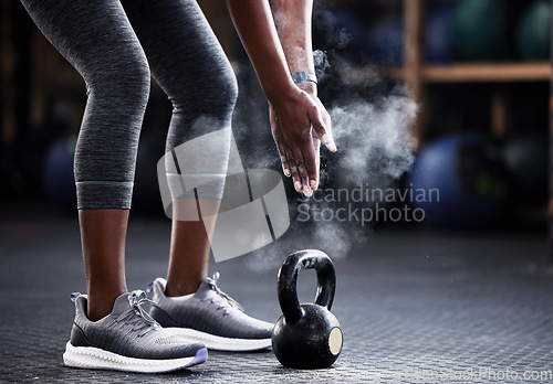 Image of Fitness, kettlebell or hands of woman with powder to start training, workout or exercise for grip strength. Body builder, floor or healthy athlete with chalk dust at gym ready for lifting weights