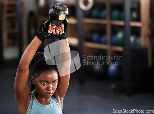 Image of Fitness, kettlebell or serious black woman in training, workout or bodybuilding exercise for grip. African body builder, girl power or strong sports athlete with at gym to start lifting heavy weights