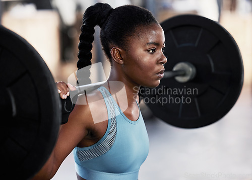 Image of Focus, barbell and woman training, exercise and workout goal with wellness, fitness and health. Female person, girl or athlete with gym equipment, strong or weightlifting with bodybuilding and sports