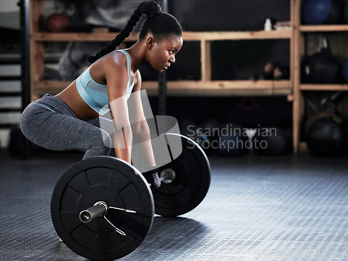 Image of Deadlift, barbell or strong girl training, exercise or workout for powerful arms or muscles for body fitness. Power lifter, strength or black woman athlete lifting weights or exercising biceps in gym