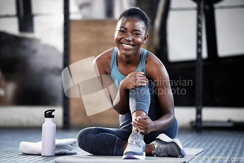 Image of Relax, portrait or happy black woman at gym for a workout, exercise or training for healthy body or fitness. Face of sports girl or African athlete smiling or relaxing on break with positive mindset