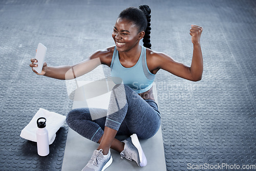 Image of Gym, fitness or happy black woman taking selfie on workout, exercise or training break on social media. Wellness, smile or healthy African girl flexing, relaxing or taking pictures for online content