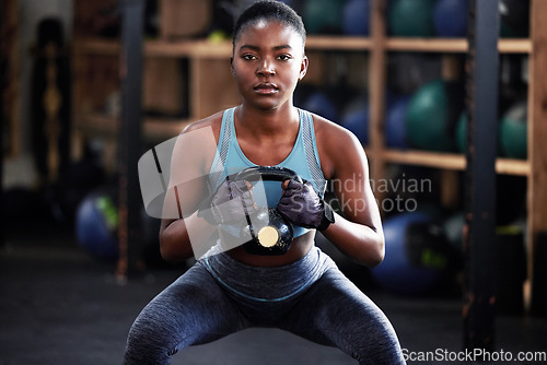 Image of Fitness, kettlebell squat or portrait of black woman in training, workout or bodybuilding exercise for grip. Body builder, power or strong sports athlete with at gym to start lifting heavy weights