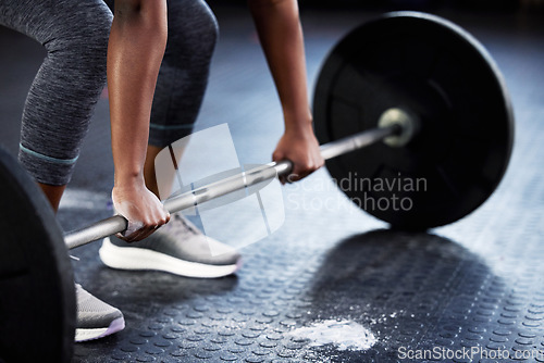 Image of Woman, barbell or hands of bodybuilder for deadlift workout, fitness exercise or strength training with powder. Powerlifting closeup or girl sports athlete weightlifting with chalk dust on gym floor