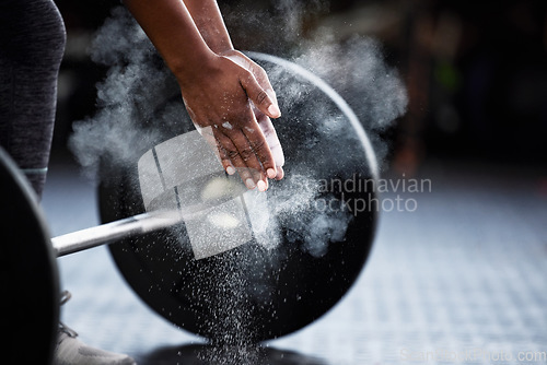 Image of Fitness, barbell or hands of bodybuilder with chalk in workout or exercise for strength training. Deadlift, powerlifting closeup or sports athlete weightlifting with powder or dust on gym floor