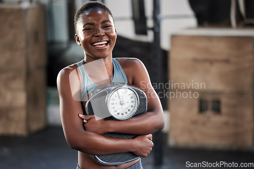 Image of Fitness, portrait or happy black woman with a scale after body training or gym workout to lose weight. Wellness, laughing or funny girl athlete in health club for exercising progress or results