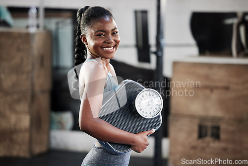 Image of Gym, portrait or happy black woman with scale after body training or fitness workout to lose weight. Wellness, personal trainer or African girl athlete in health club for exercising progress results