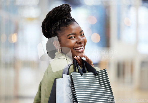 Image of Black woman, shopping bag and portrait smile for discount, payment or sale in fashion at retail mall or store. Happy African female person or shopper smiling with gift bags, products or purchase