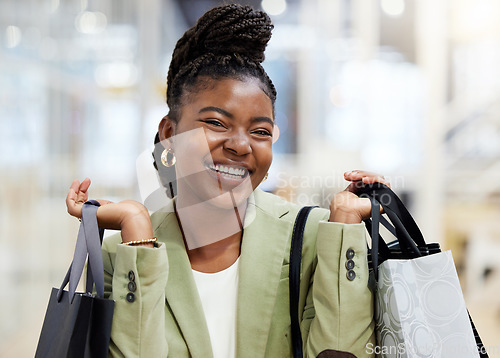 Image of Black woman, shopping bag and portrait smile in sale, discount or payment for fashion at retail mall or store. Happy African female person or shopper smiling with gift bags, products or purchase