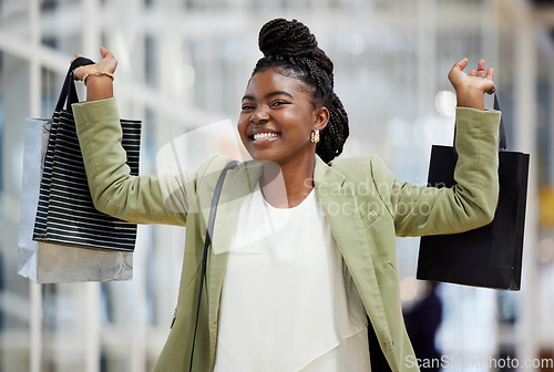 Image of Black woman, portrait smile and shopping bag for payment, discount or sale at retail store or mall. Face of happy African female person or shopper smiling with gift bags, buy products or purchase