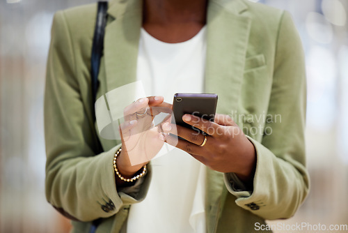 Image of Woman, hands and phone in communication, social media or texting in online networking or app at office. Hand of female person typing or chatting on mobile smartphone or browsing internet at workplace