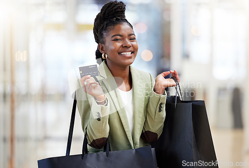 Image of Black woman, credit card and shopping bag for payment, ecommerce or banking at the mall. Portrait of happy African female person or shopper smile for bank, discount or sale in online purchase or buy