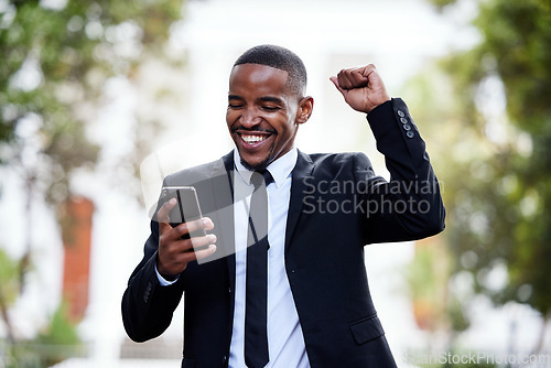 Image of Black man, business and phone with celebration in street for winning, trading profit or bonus in city. African businessman, smartphone and winner on internet for esports, gambling or promotion at job