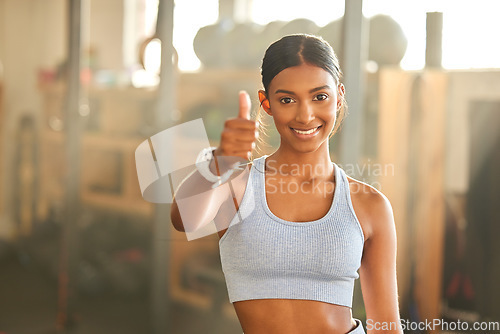 Image of Gym, portrait or Indian woman with thumbs up in fitness training with positive mindset or motivation. Encouragement, support or happy personal trainer in workout with like hand sign or thumb up