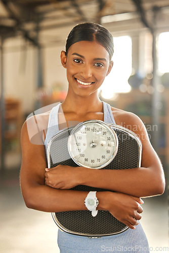 Image of Fitness, portrait or happy Indian woman with scale after body training or gym workout to lose weight. Wellness, personal trainer or sports girl athlete in health club for exercising progress results