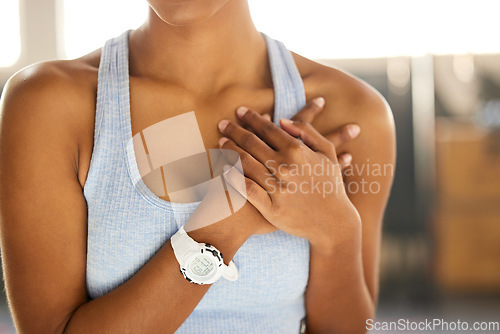 Image of Hands, heart attack or woman in gym with chest pain or cardiac arrest in workout or fitness exercise. Zoom, emergency accident risk or injured sports athlete holding her body or breast for injury