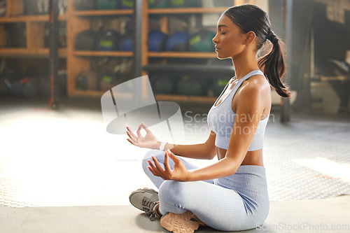 Image of Meditation, yoga and Indian woman in gym for wellness, mindfulness and breathing exercise on floor. Mental health, meditate and female person in lotus pose for calm, zen and balance in training