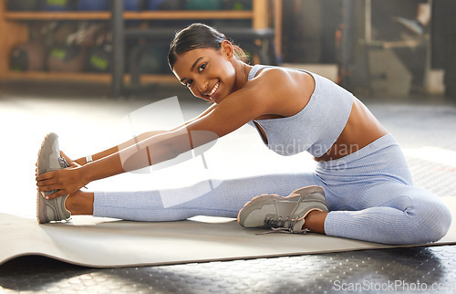 Image of Gym, portrait or Indian woman stretching legs for workout routine or body movement for active fitness. Healthy, athlete or happy girl smiling in exercise training warm up for flexibility or mobility