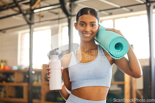 Image of Mat, portrait or Indian woman with water in gym ready for training, workout or exercise with smile. Fitness, athlete smiling or happy girl with bottle for healthy liquid hydration to start exercising