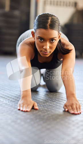 Image of Portrait, fitness or woman stretching spine in gym preparation for exercise, workout or wellness. Face of girl, warm up or flexible Indian athlete exercising for mobility training or back flexibility
