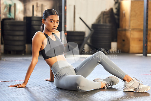 Image of Portrait, fitness or Indian woman on break in gym relaxing ready for sports exercise, workout or wellness. Tired athlete, floor or healthy girl bodybuilder resting for recovery after exercising