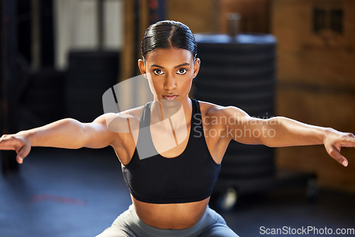 Image of Portrait, fitness or woman doing squats at gym in exercise, workout or leg strength training for wellness. Powerful, female athlete or focused girl exercising legs for strong glutes or bodybuilding
