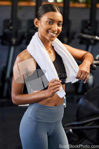 Image of Fitness, portrait or happy Indian woman at gym for a workout, exercise or training for healthy body. Face, sports girl or proud athlete smiling or relaxing with positive mindset, smile or wellness